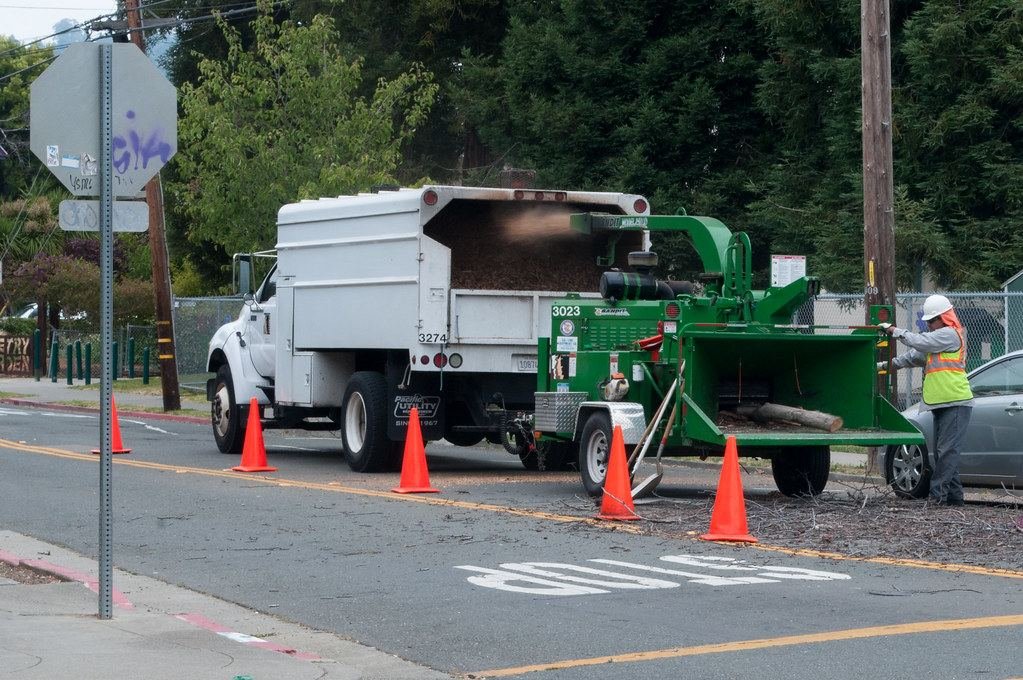 Tree crew with a chipper truck on a residential street